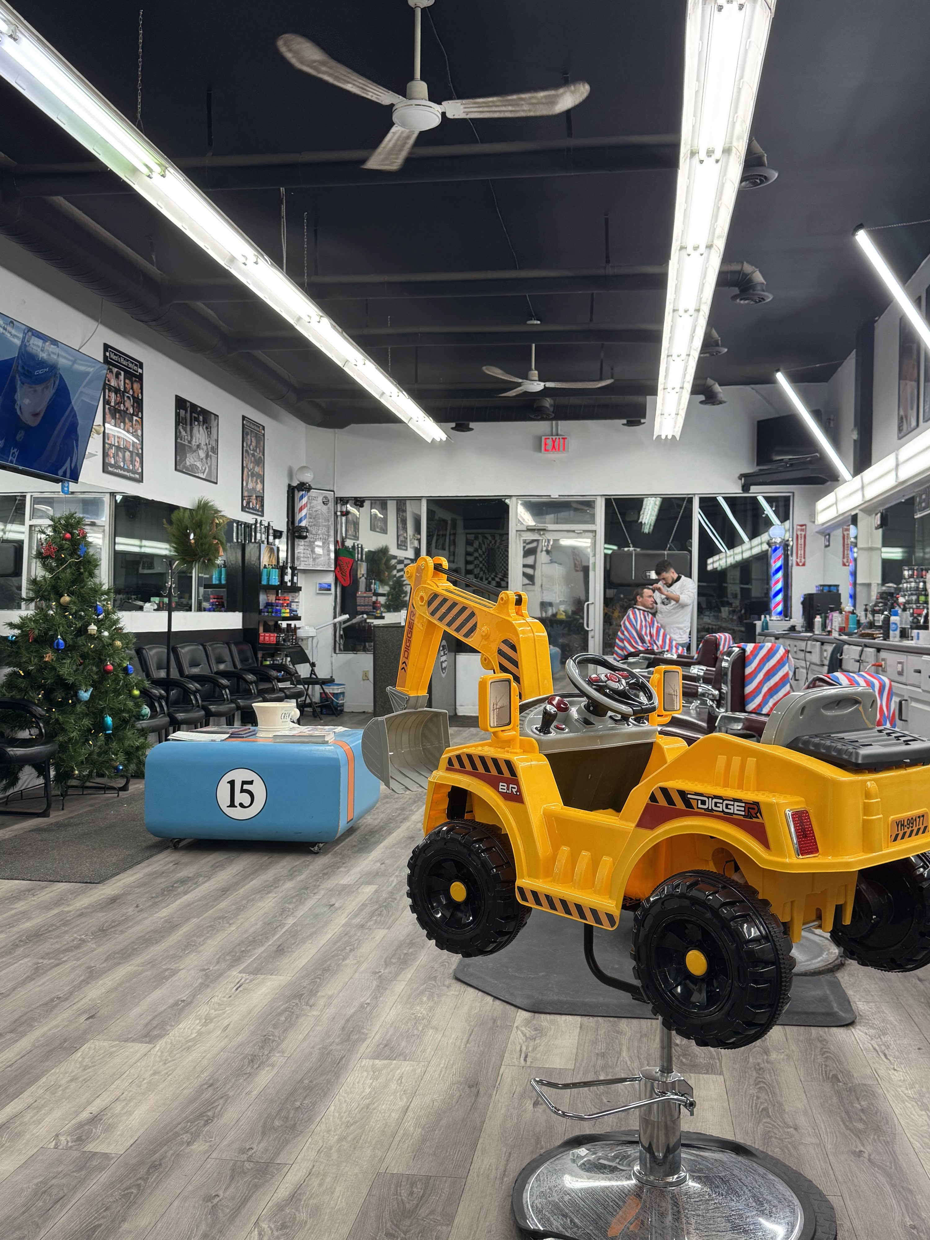 The Barbershop FSJ interior with excavator barber chair — Mackenzie Mall, Fort St John BC